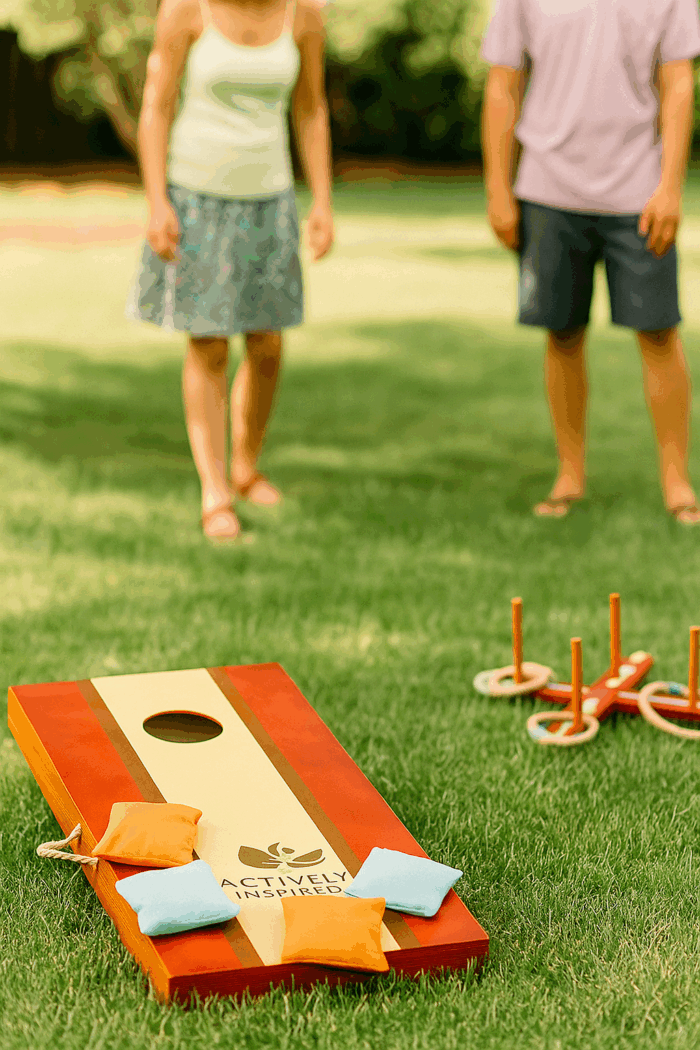 People playing cornhole toss game