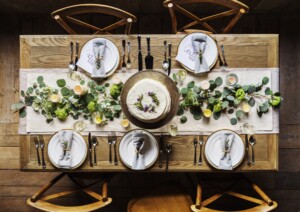 Styled dining table with neutral tones and a few sculptural objects.